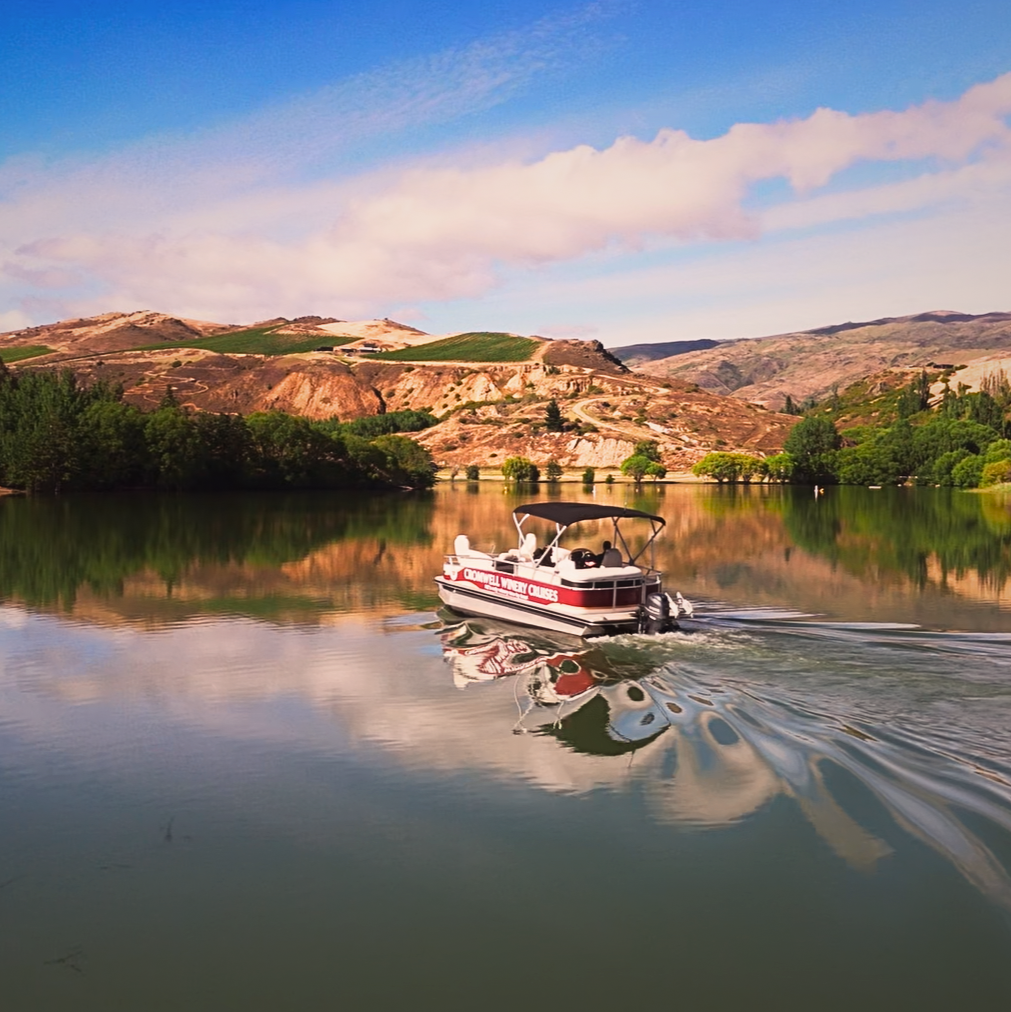 Cromwell Winery Cruises boat on Lake Dunstan beneath Central Otago vineyards